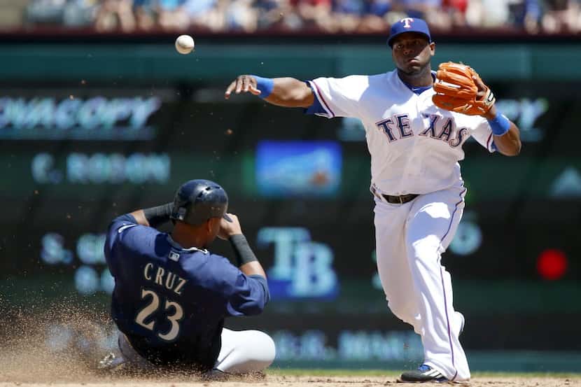 Texas Rangers shortstop Hanser Alberto (2) throws a ball to first after forcing out Seattle...
