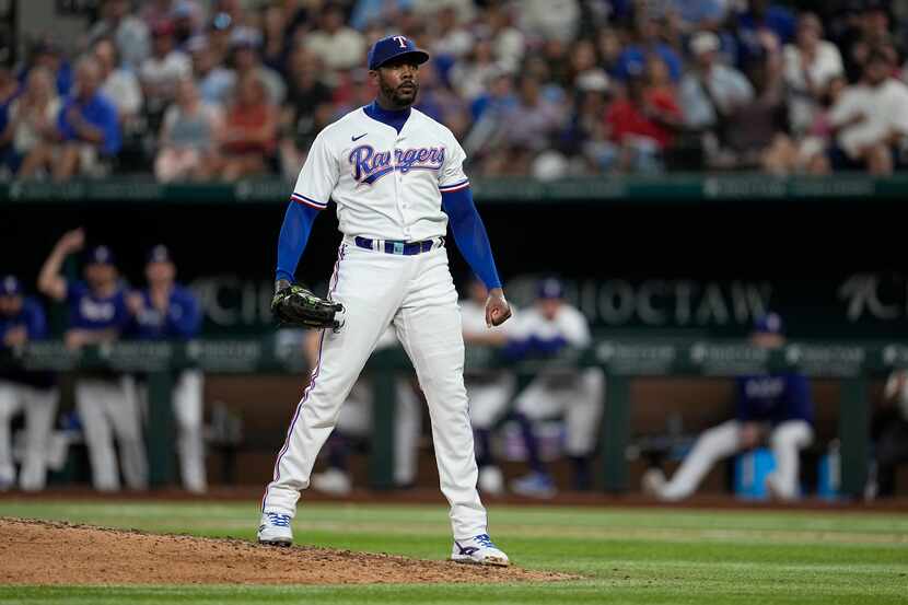 Texas Rangers pitcher Aroldis Chapman stands at the end of the mound after striking out...