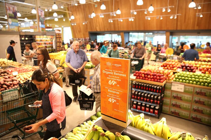 A sign stating the lower price of bananas during a pre-shopping event at the new Whole Foods...