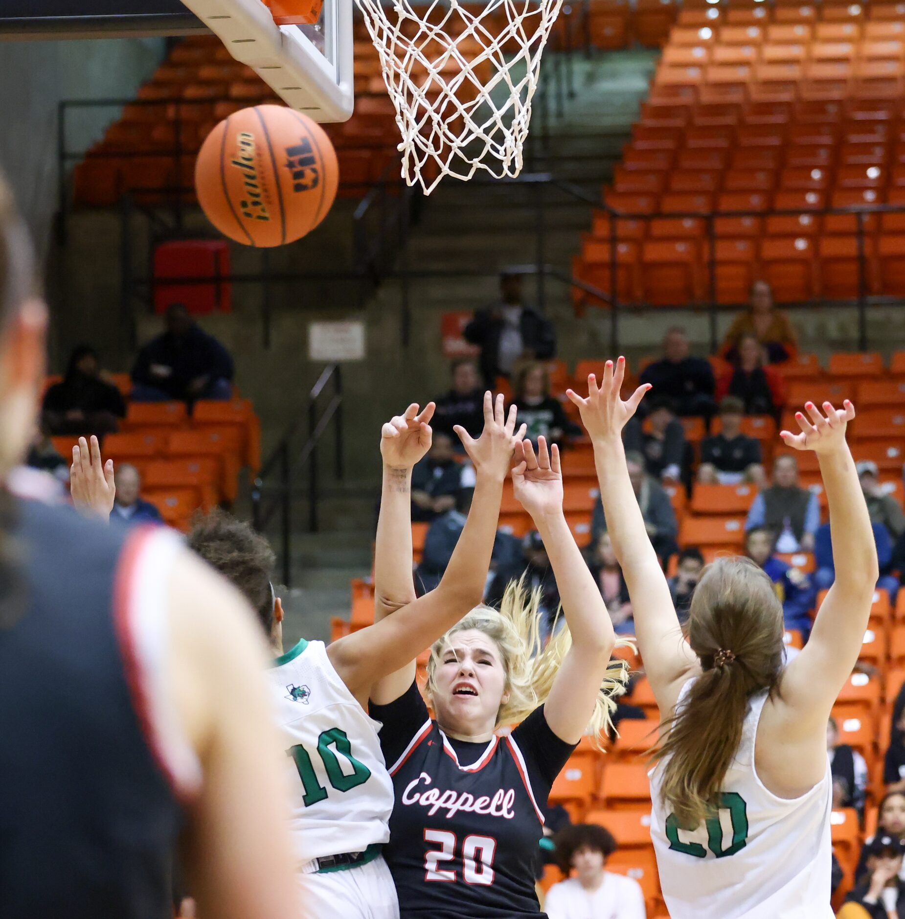 Coppell senior guard Julianna LaMendola (20) falls backward as she throws the ball to a...