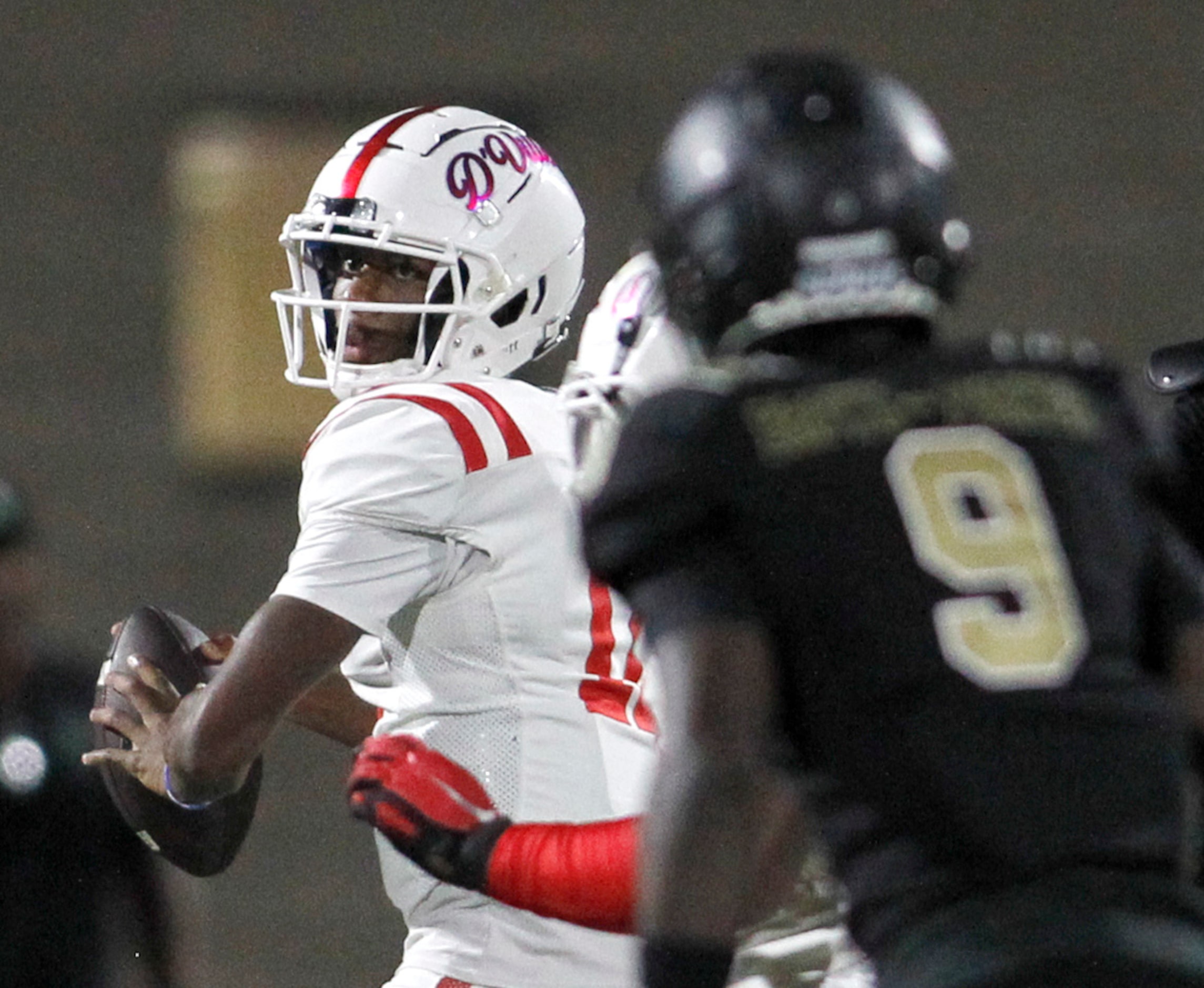 Duncanville quarterback Keelon Russell (12), left, looks to pass downfield as South Oak...