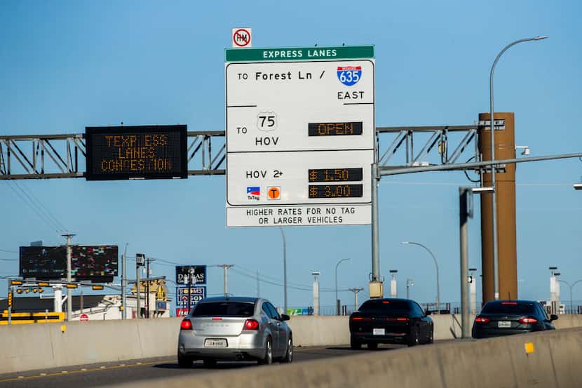 Vehicles pass a sign for Interstate 635 Express toll road near Forest Lane on Thursday,...