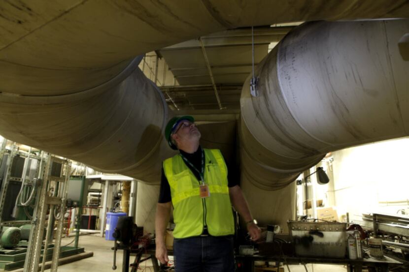Contractor Danny Moran oversees the energy system installation in the boiler room at the...