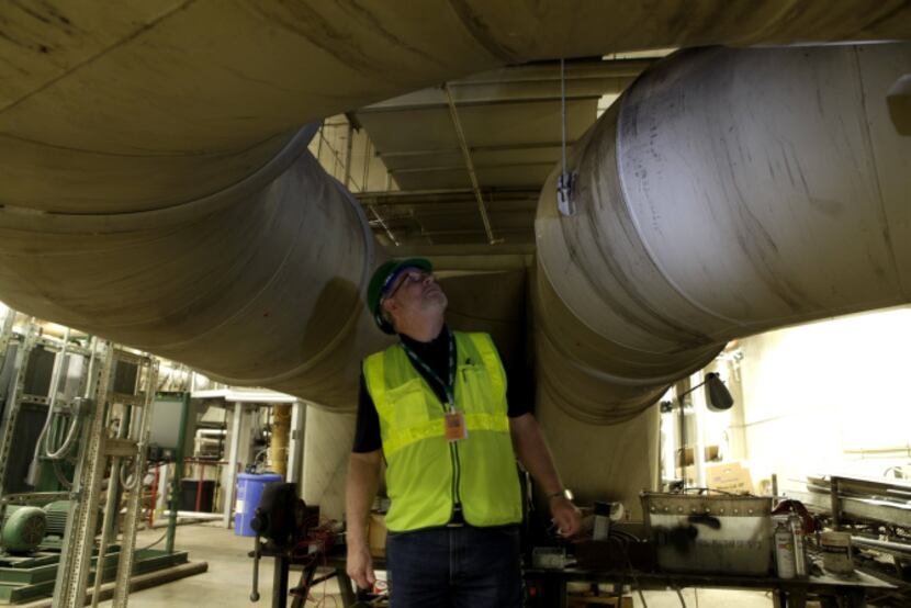 Contractor Danny Moran oversees the energy system installation in the boiler room at the...