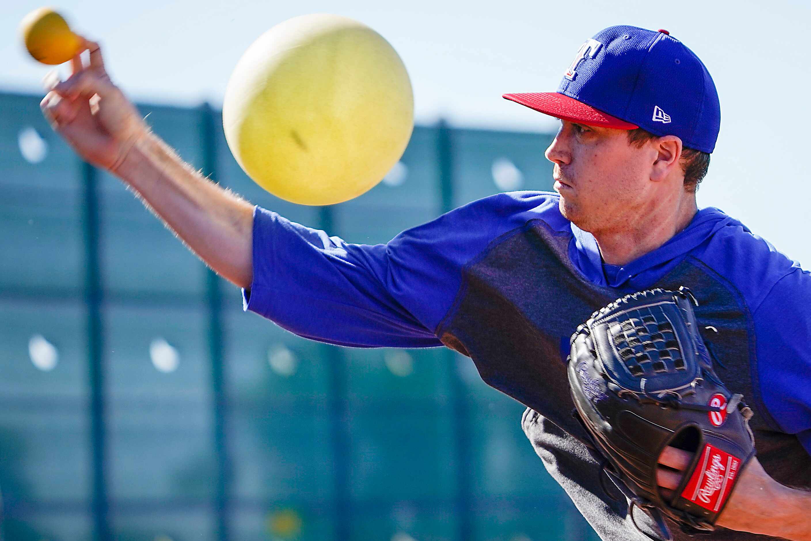 Texas Rangers pitcher Kyle Gibson works with a heavy ball and a connection ball (inflatable...