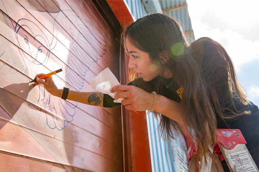 Artist Rose Rodriguez works on her mural on as part of The Wild West Mural Fest in Dallas on...
