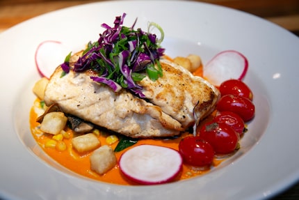 The redfish en la media concha at Mesero is a seared redfish, cherry tomato, roasted corn,...