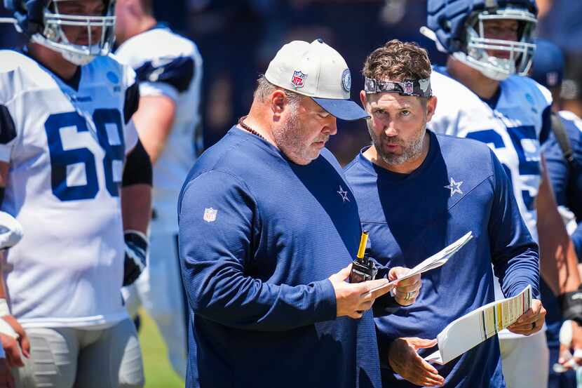 Dallas Cowboys offensive coordinator Brian Schottenheimer (right) confers with head coach...