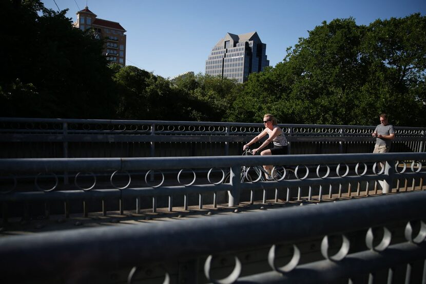  Bicyclists and pedestrians utilize the Katy Trail near the Katy Trail Ice House in Dallas...