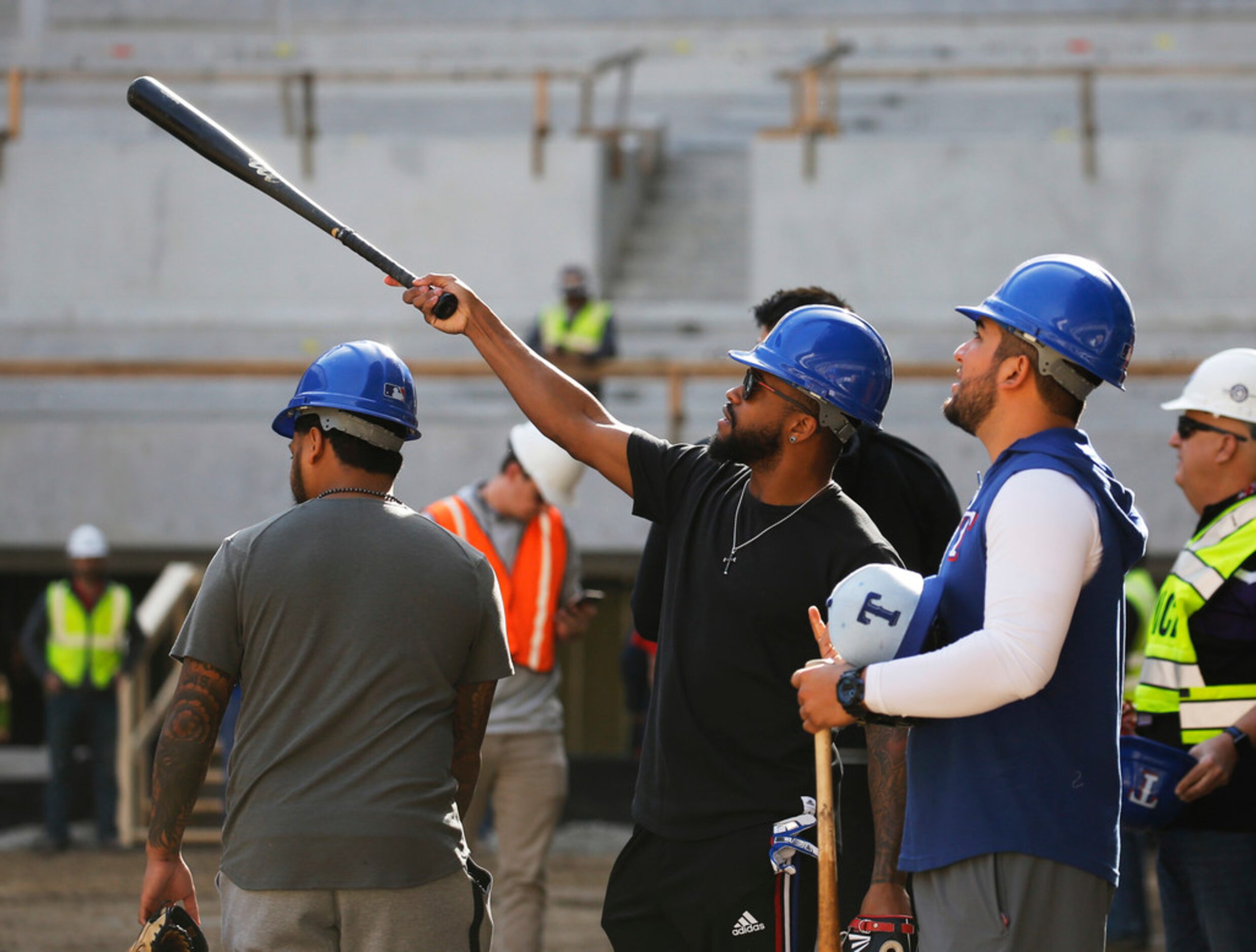 Texas Rangers Delino DeShields (center) talks with Willie Calhoun (right) and Jose Trevino...