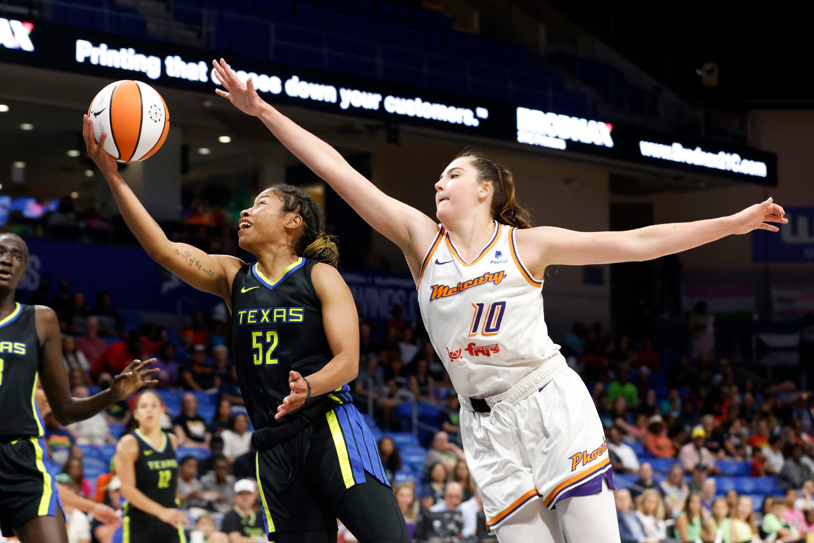 Dallas Wings guard Tyasha Harris (52) makes a basket in front of Phoenix Mercury center...