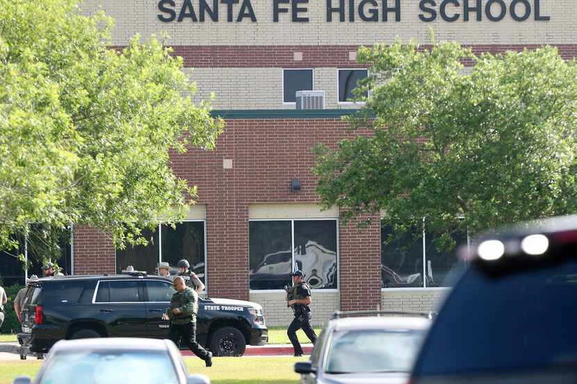 Law enforcement officers respond to Santa Fe High School after an active shooter was...