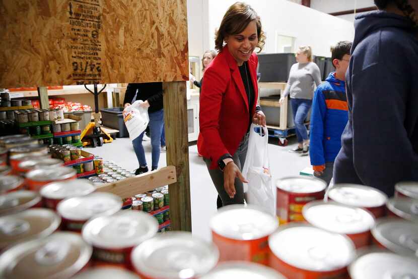 Volunteer April Leonard assembles meals for qualifying children at Frisco Fastpacs...
