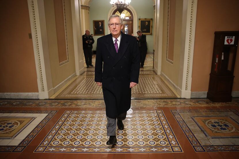 Senate Majority Leader Mitch McConnell returns to the U.S. Capitol just before midnight...