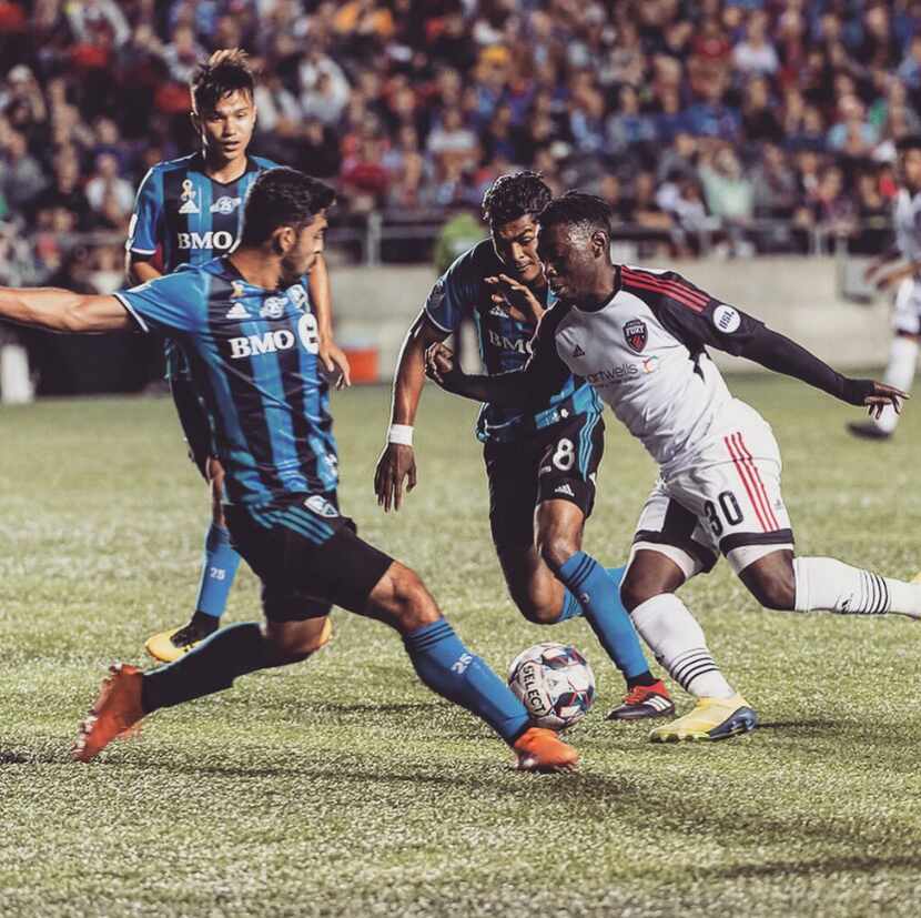 Adonijah Reid takes on three Montreal Impact defenders in the 2018 CapCity Cup.