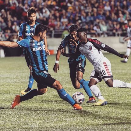 Adonijah Reid (in white) takes on three Montreal Impact defenders in the 2018 CapCity Cup.