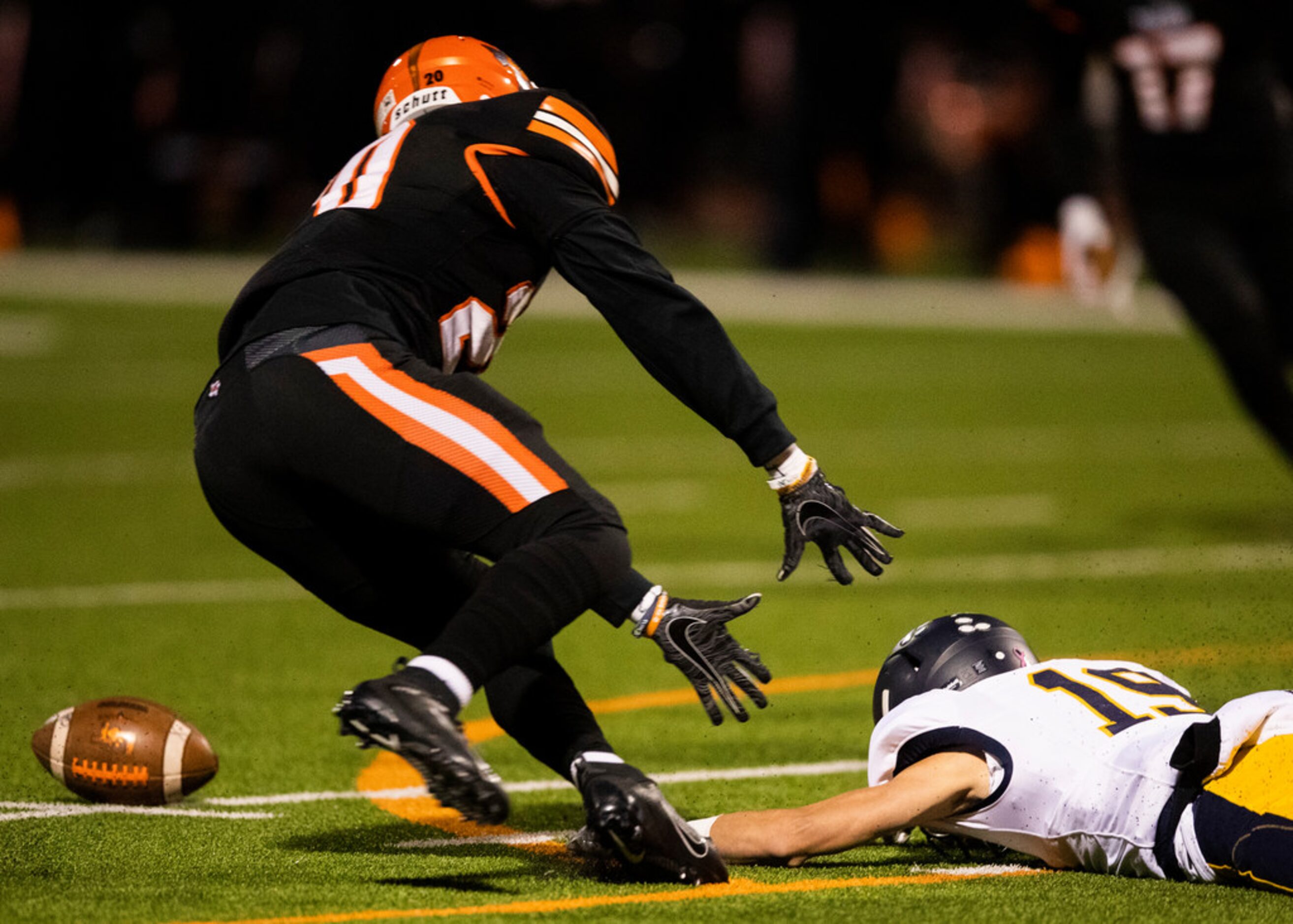 Lancaster defensive back Kahn Rollerson (20) reaches for a loose ball fumbled by Highland...