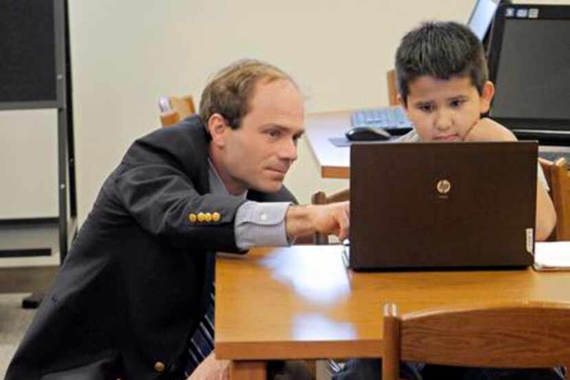 
Assistant Principal Robert Stewart works with Diego Aspeitia, 8, who came in over spring...