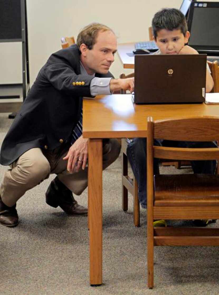 
Assistant Principal Robert Stewart works with Diego Aspeitia, 8, who came in over spring...