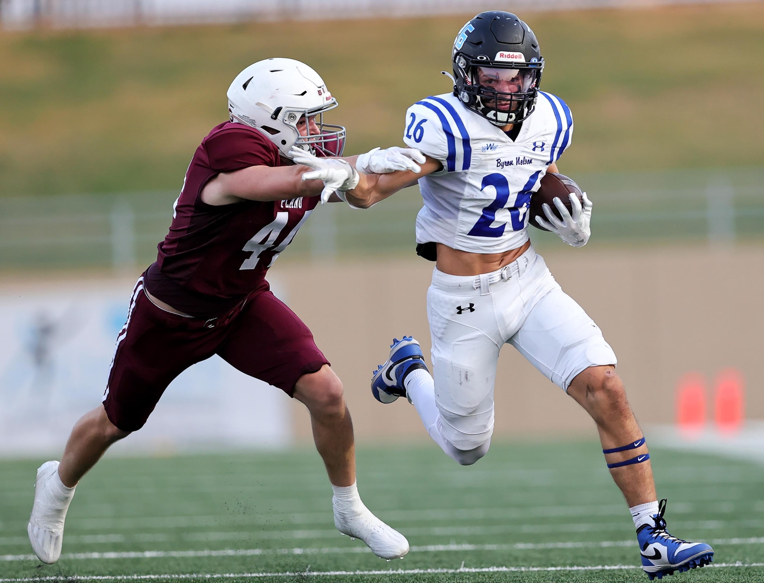 Byron Nelson running back Tucker James (26) tries to elude Plano linebacker Owen Welch (44)...