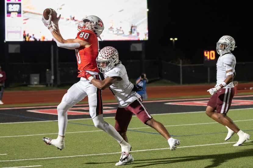 Coppell wide receiver Baron Tipton (80) catches a pass over Plano defensive back Kevin Grady...