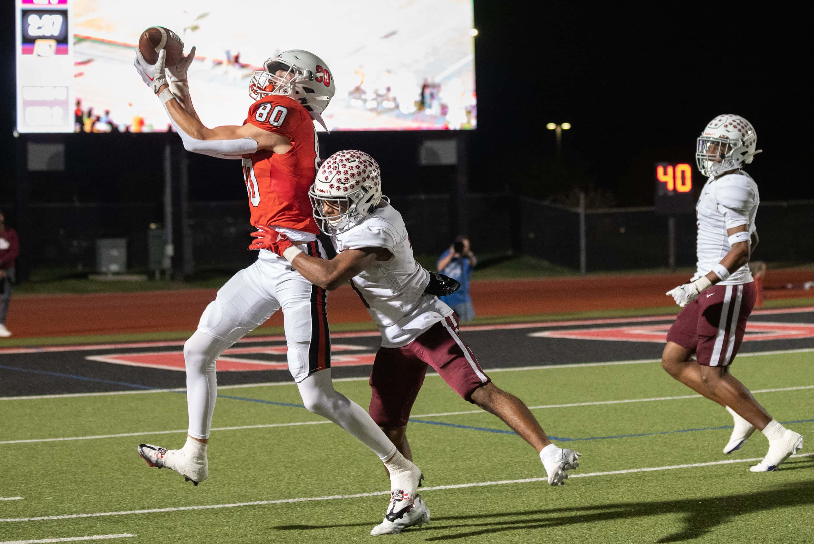 Coppell wide receiver Baron Tipton (80) catches a pass over Plano defensive back Kevin Grady...