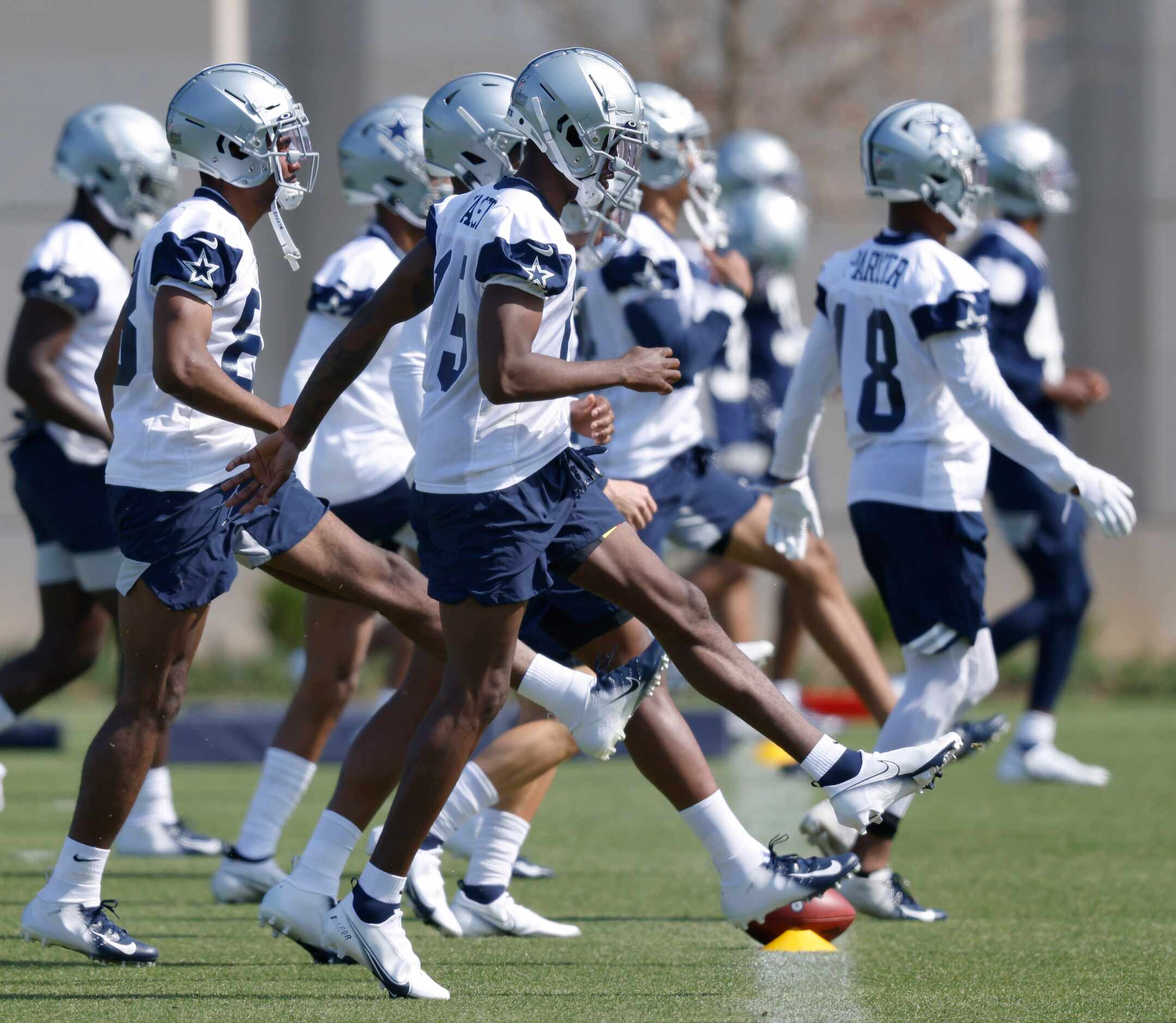 Dallas Cowboys rookie wide receiver T,J,. Vasher (15) and his teammates warm up during...