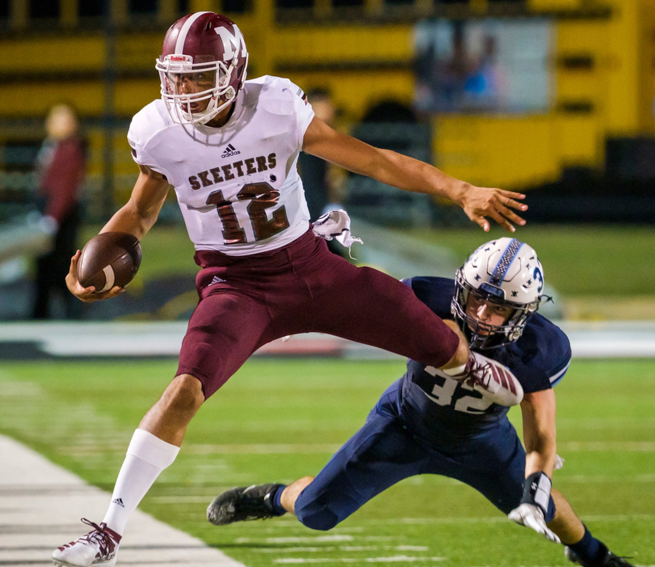 Mesquite quarterback Dylan Hillard-McGill (1is pushed out of bounds by L.D. Bell middle...