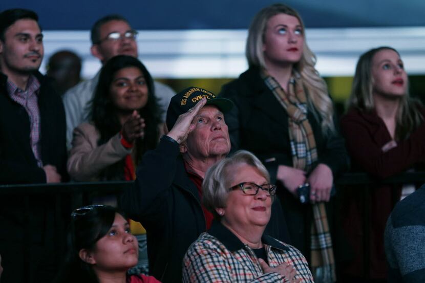 A veteran salutes during the National Anthem before stars arrived on the red carpet at the...
