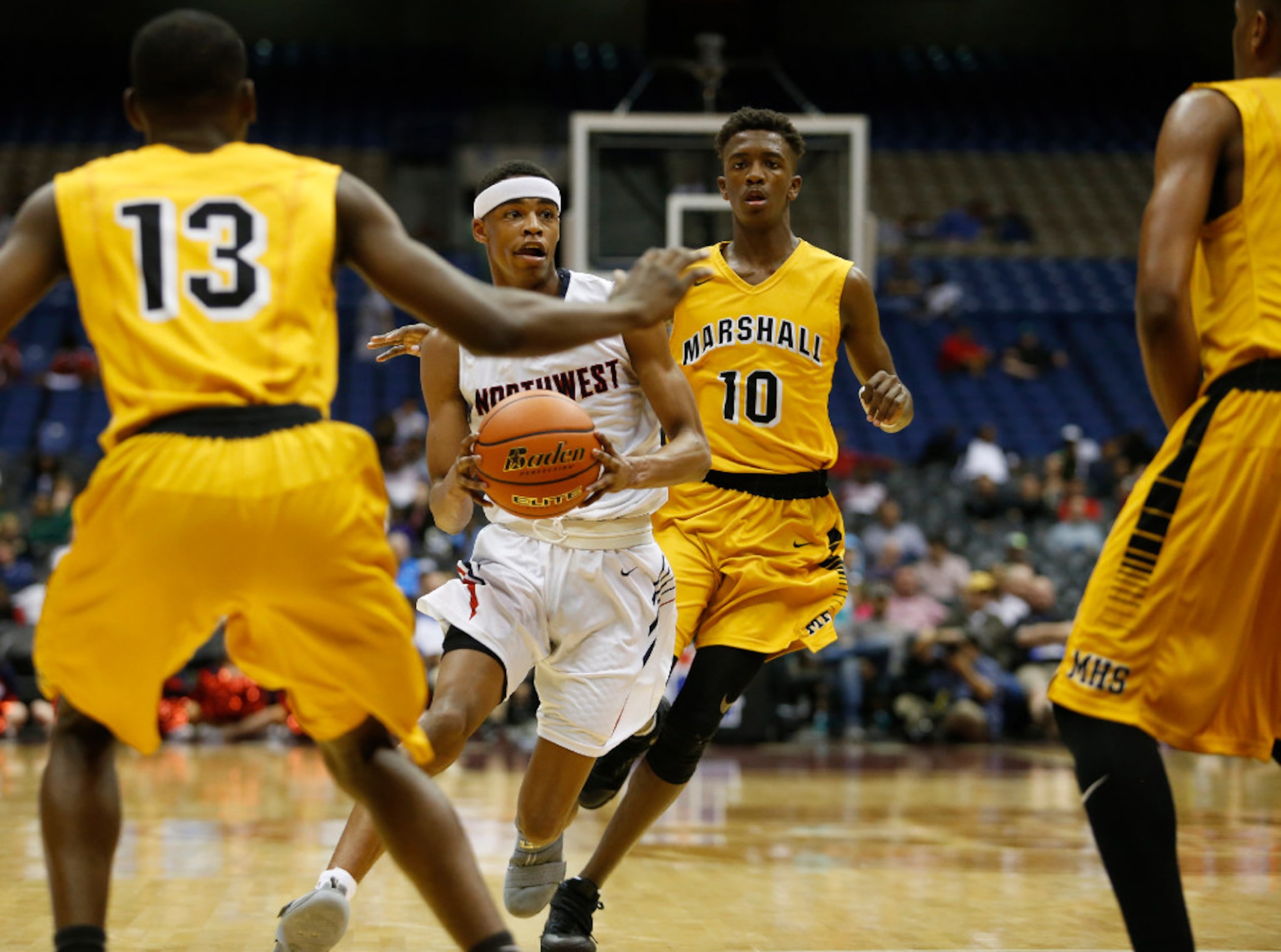 Justin Northwest's Avery Anderson (3) looks to dribble between Fort Bend Marshall's Dakota...