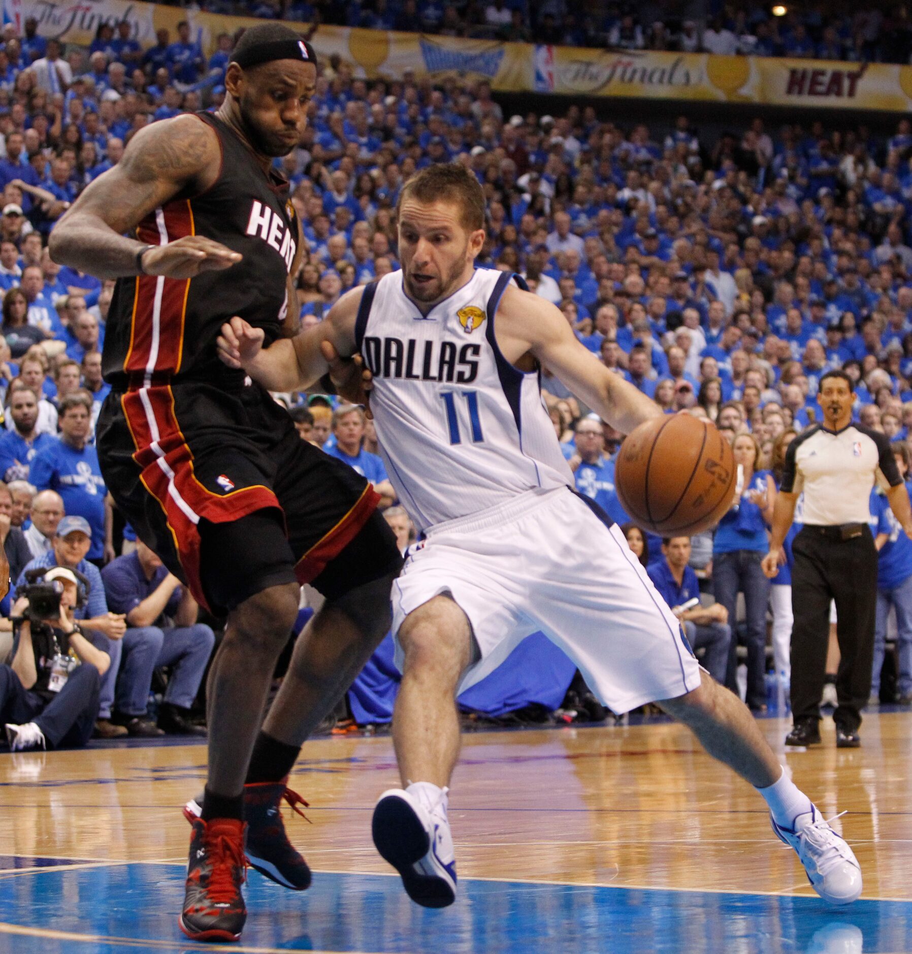 Dallas Mavericks point guard Jose Juan Barea (11) tries to drive past Miami Heat small...