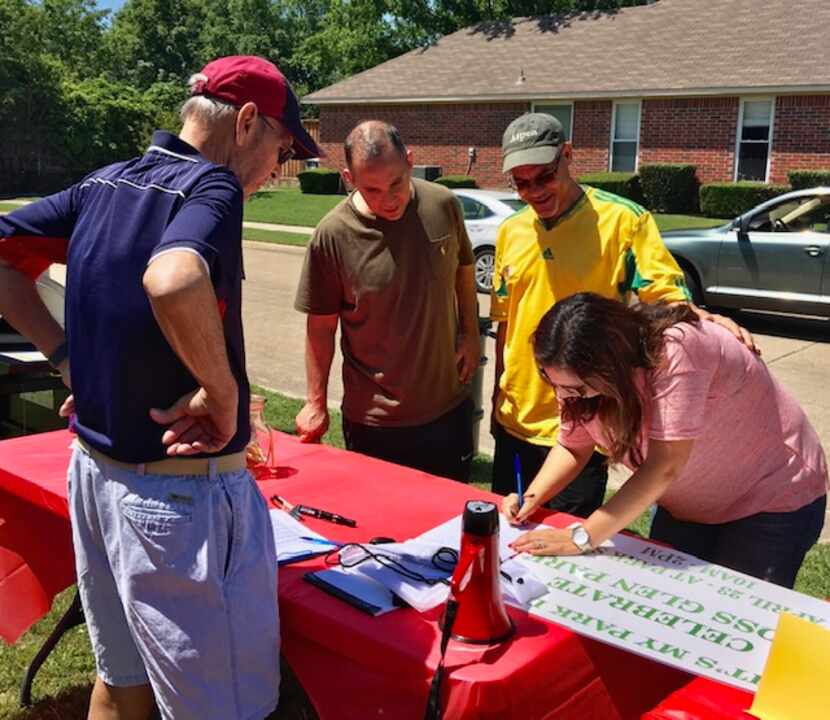 Bruce Hatter (left) signs up volunteers at one of the community events.