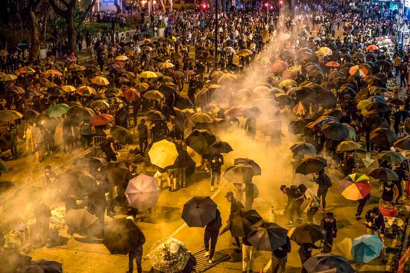 Protesters reacted as police fires tear gas while they attempt to march towards Hong Kong...
