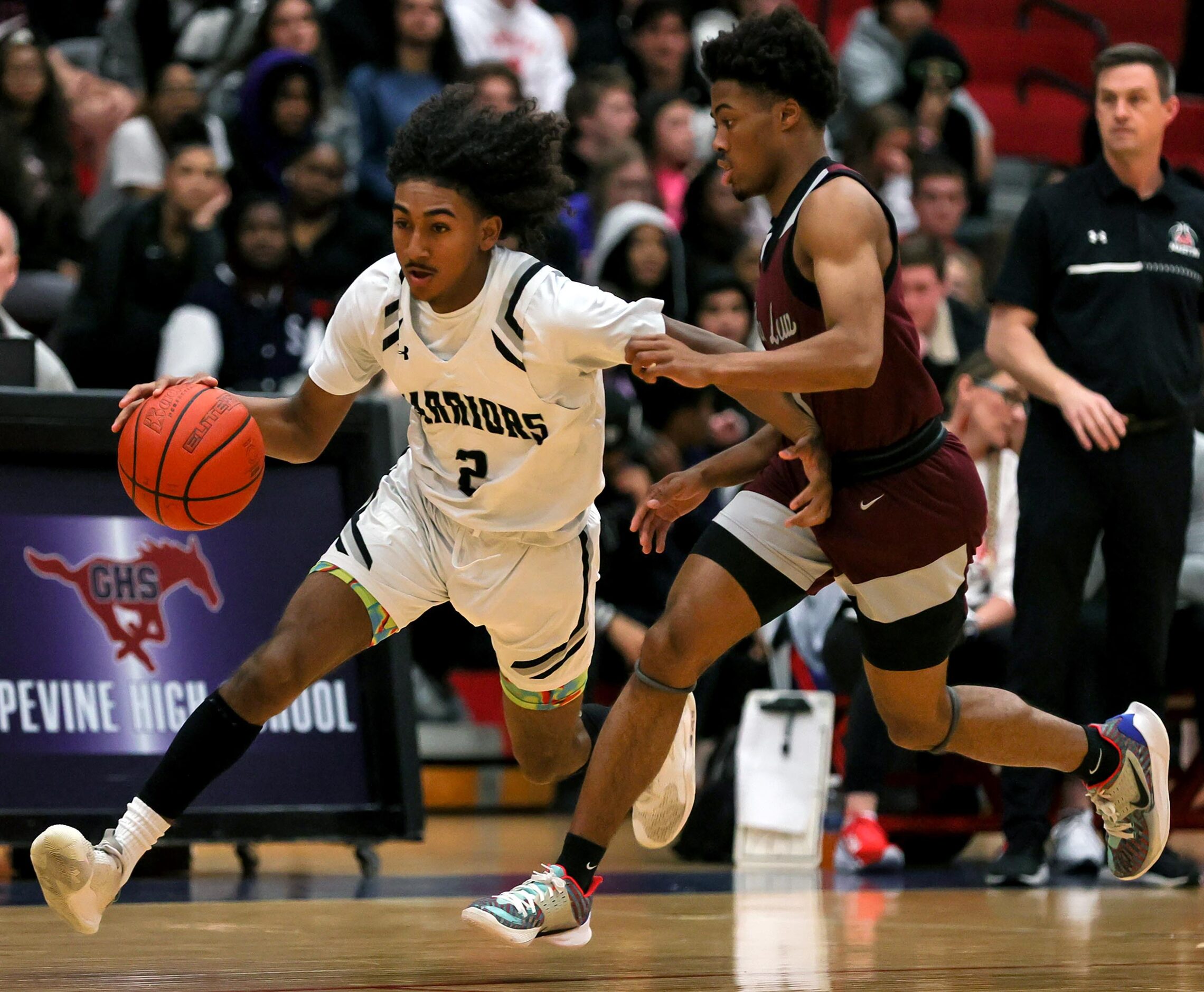 Arlington Martin guard Jaden Juarez (2) drives past Lewisville guard Tre'lin Green, (right)...