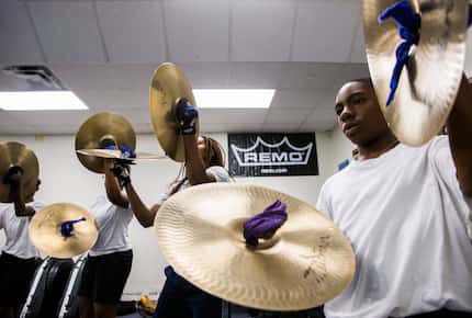 Cymbal player Devin Smith-Brighton (right) practices with the rest of the Wilmer-Hutchins...