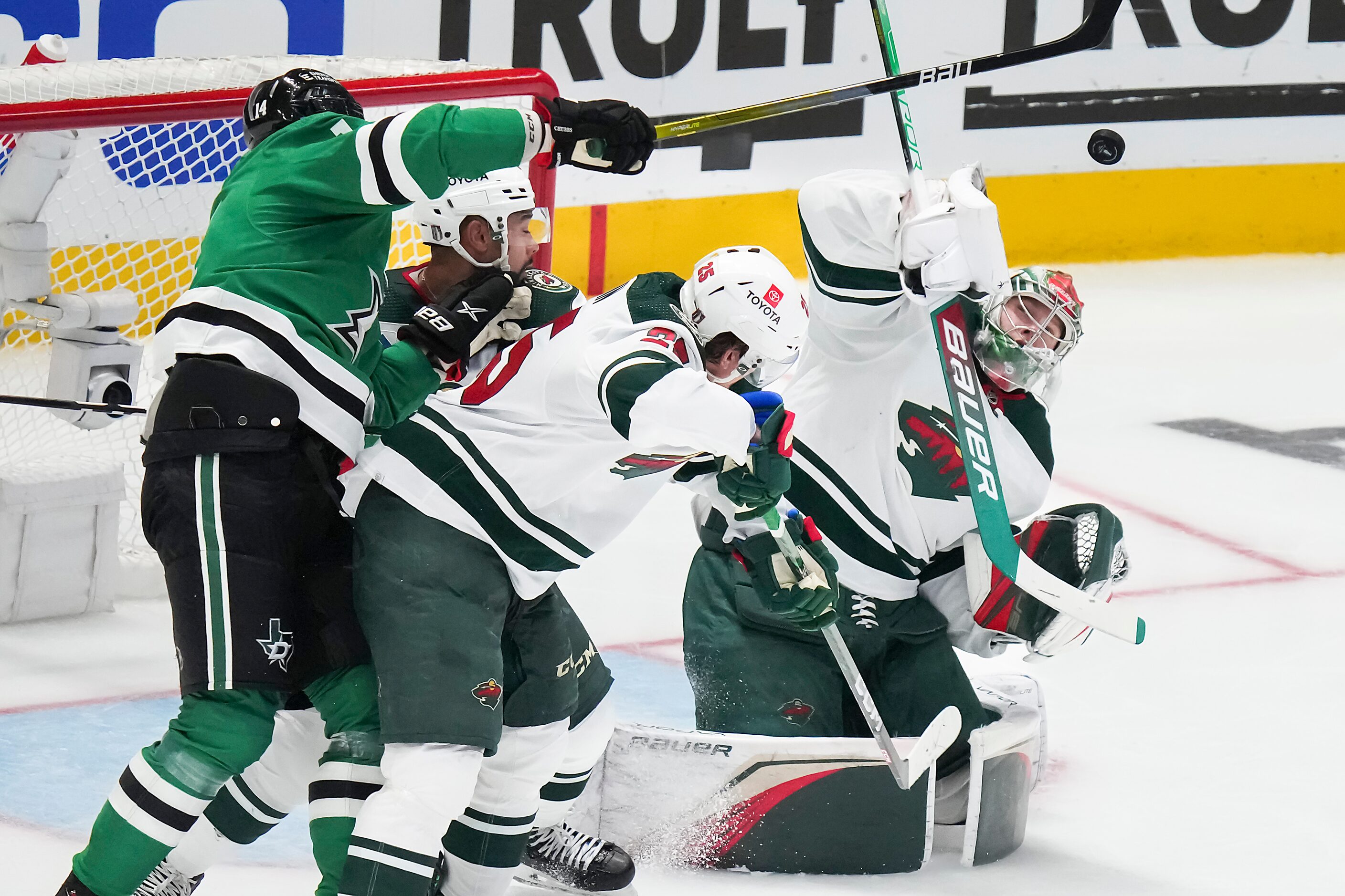 Minnesota Wild goaltender Filip Gustavsson (32) reaches to deflect a high rebound during the...