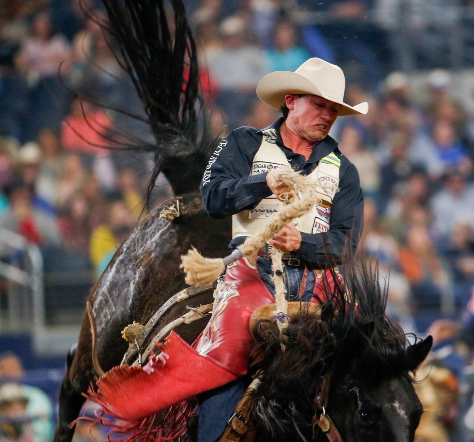 Saddle Bronc rider Cole Elshere competes in RFD-TV's The American rodeo at AT&T Stadium on...