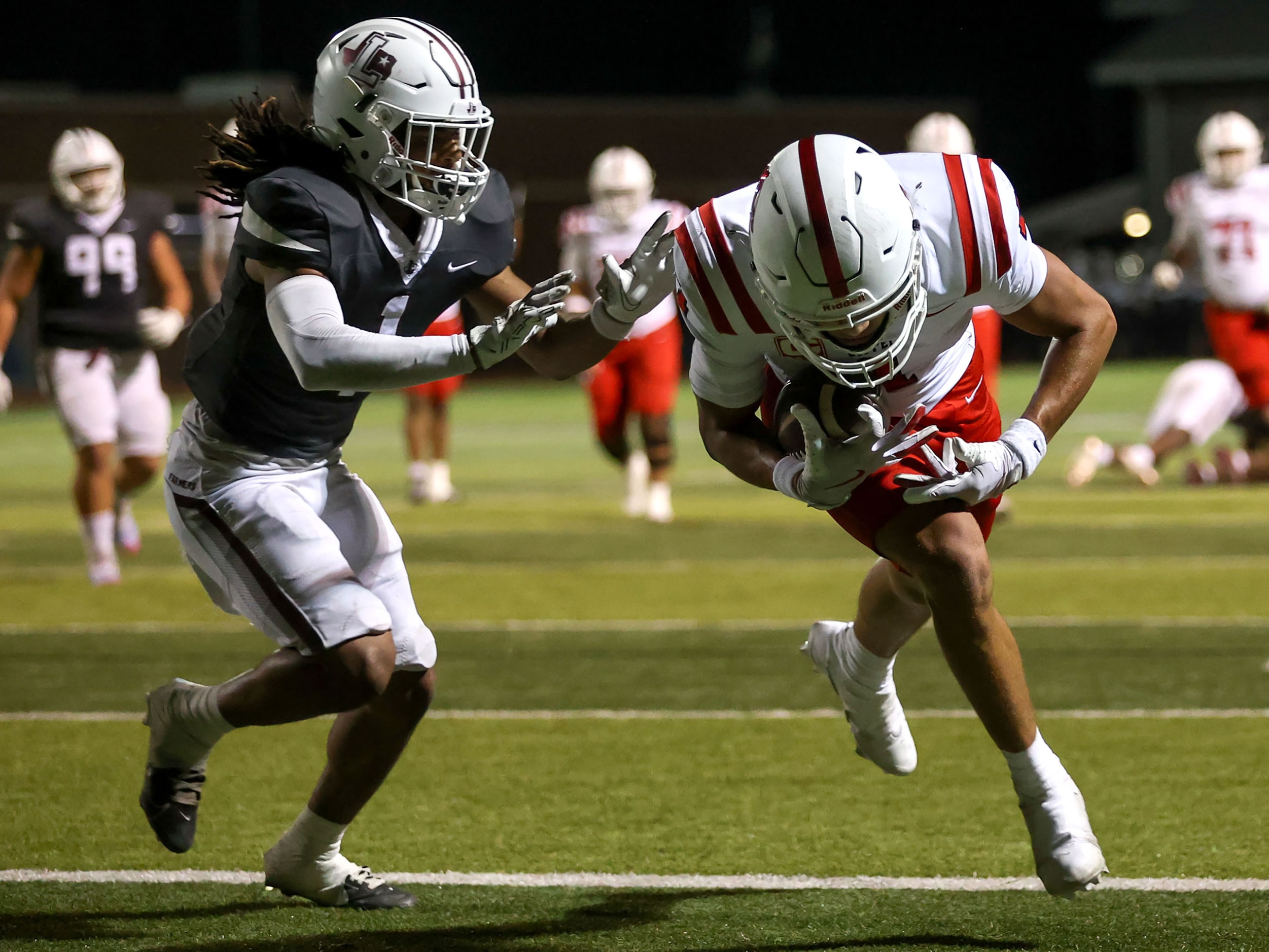 Coppell wide receiver Tucker Cusano (R) comes up with a 17 yard touchdown reception against...