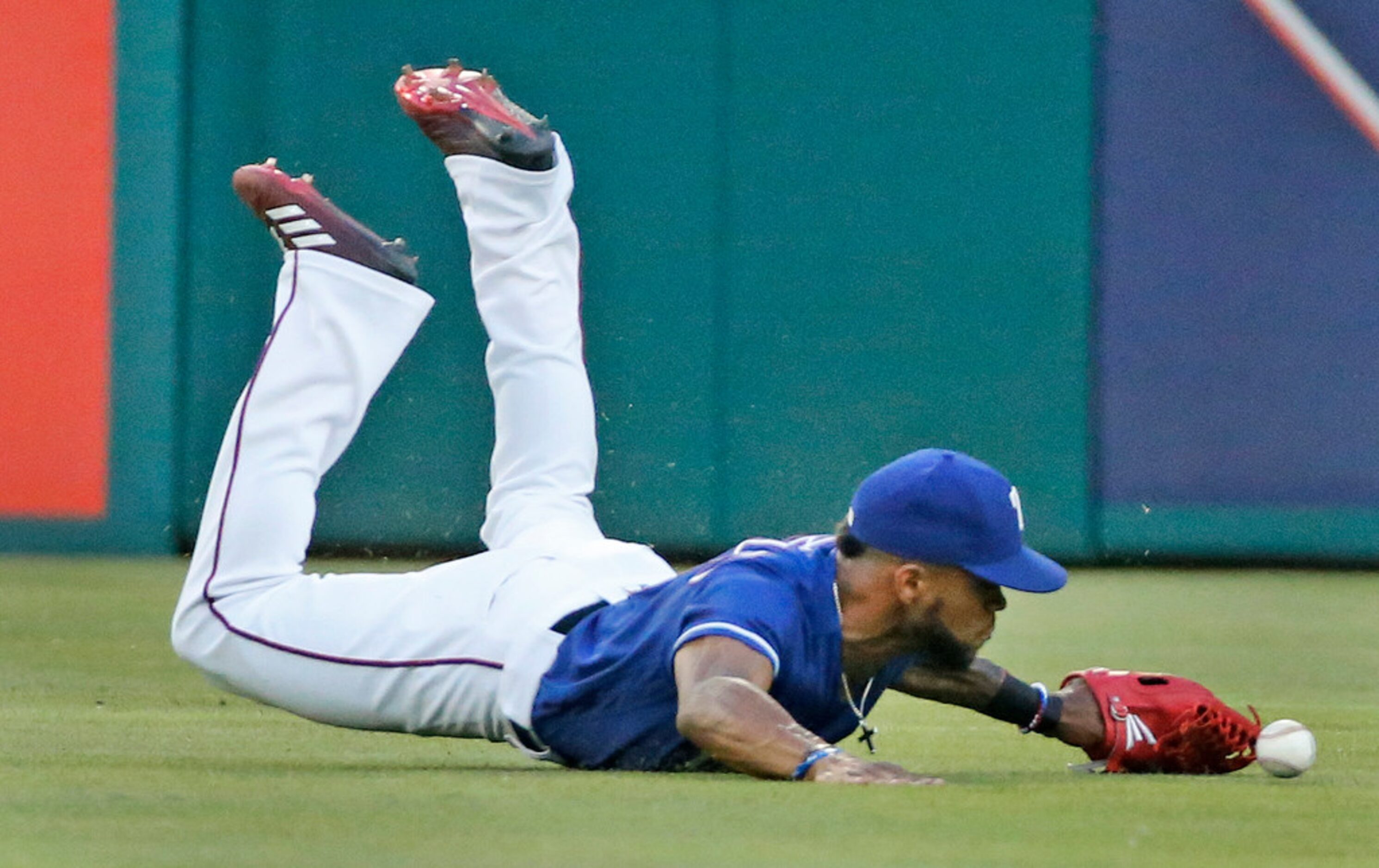 Texas Rangers center fielder Delino DeShields (3) dives but can't quite get Gary Sanchez's...