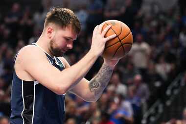 Dallas Mavericks guard Luka Doncic reacts after not getting a favorable foul call on a drive...