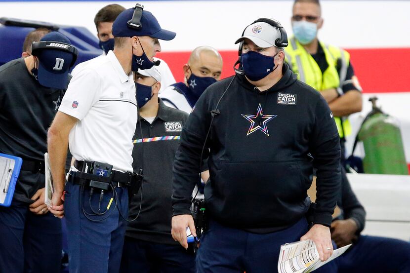 Dallas Cowboys head coach Mike McCarthy (right) visits with his special teams coordinator...