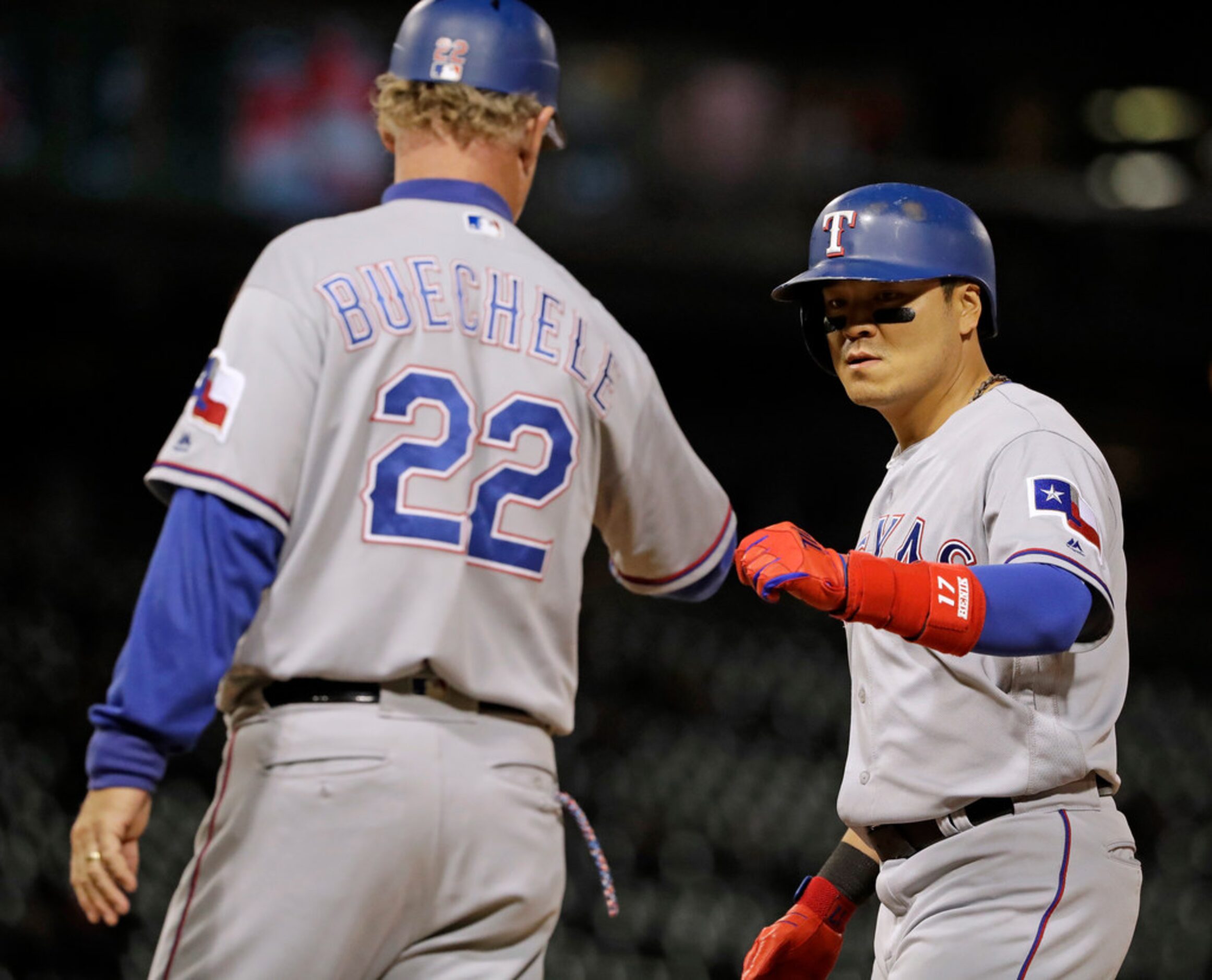 Texas Rangers' Shin-Soo Choo, right, of South Korea, celebrates with first base coach Steve...