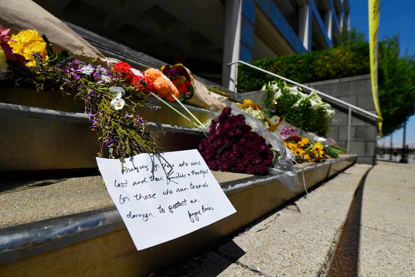 Flowers and a message were left on the stairs of the Old National Bank of Louisville on...