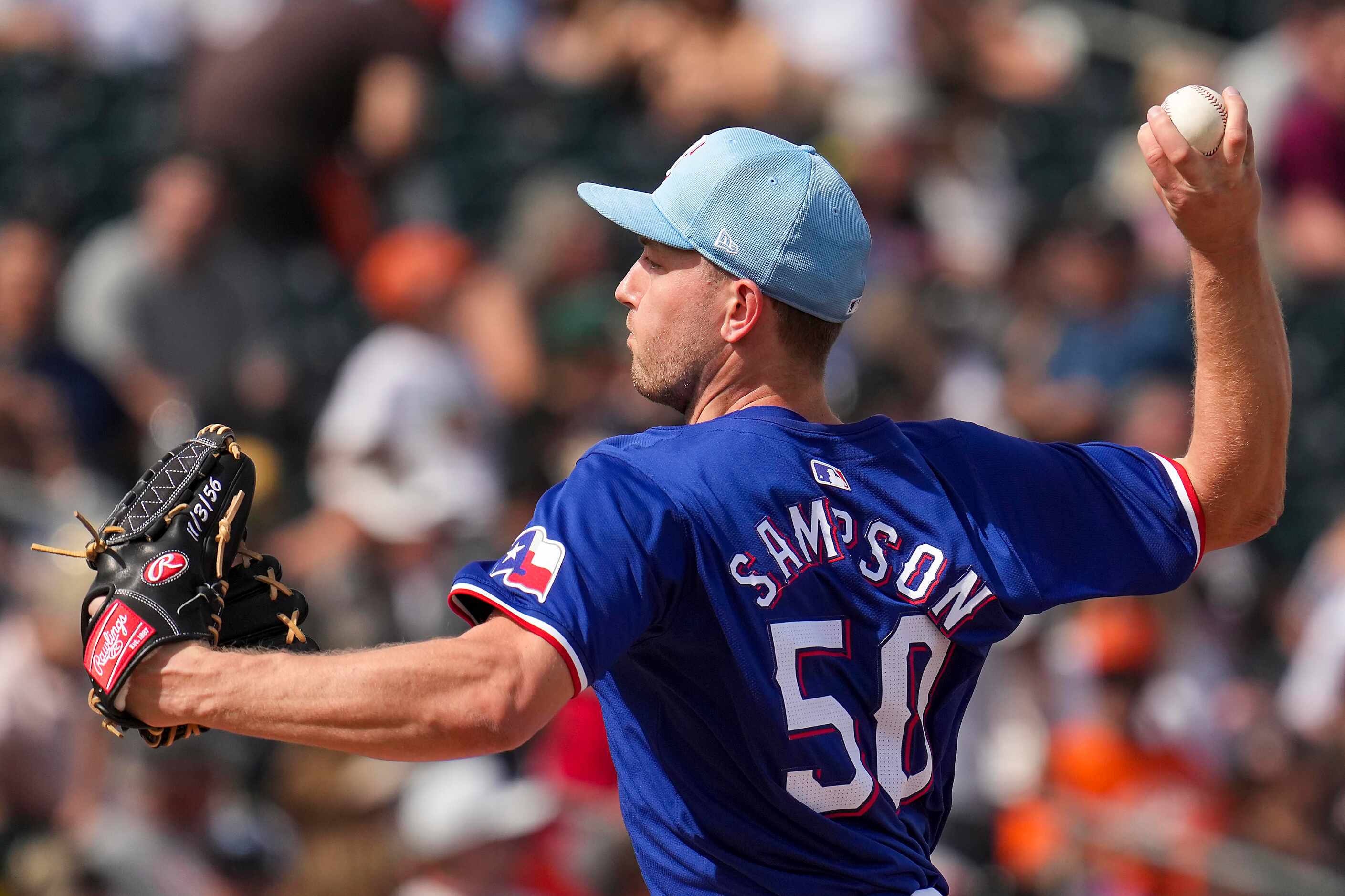 Texas Rangers pitcher Adrian Sampson delivers during the third inning of a spring training...
