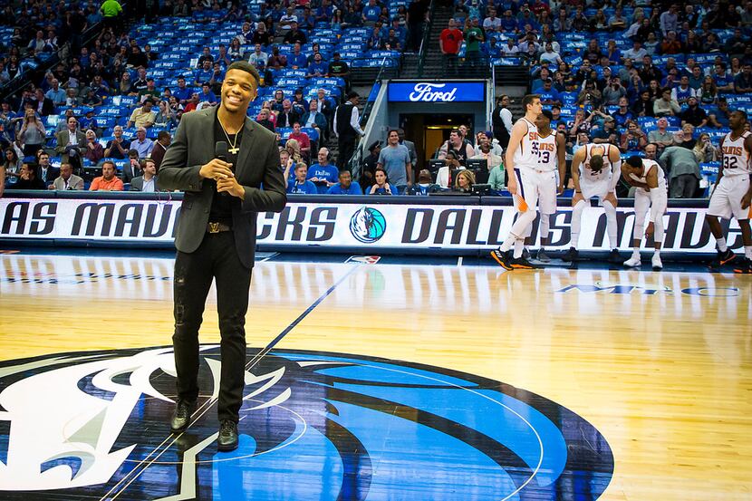 Dallas Mavericks guard Dennis Smith Jr. addresses the fans before the season finale against...