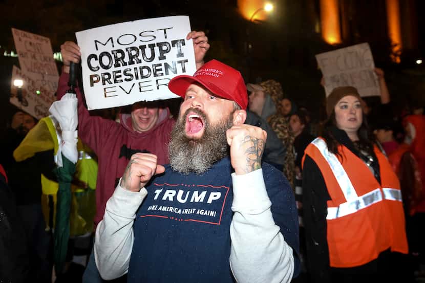 A Trump supporter chanted "Trump 2020" while making his way through crowd of anti-Trump...