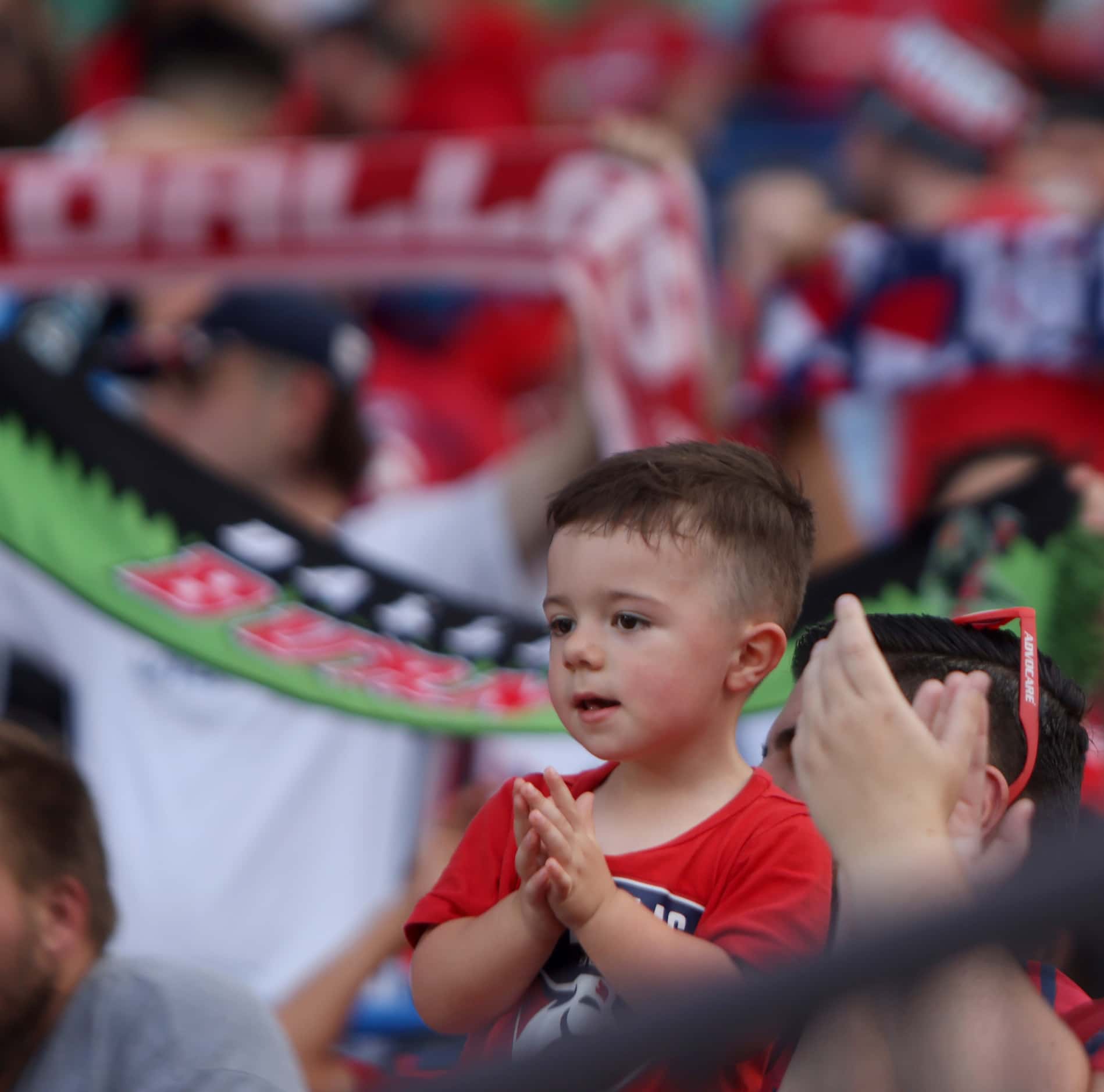 A young fan applauds  FC Dallas players as they come onto the field prior to the start of...