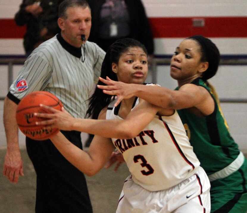 Euless Trinity guard Trinity Oliver (3) searches for an open teammate as she is pressured by...