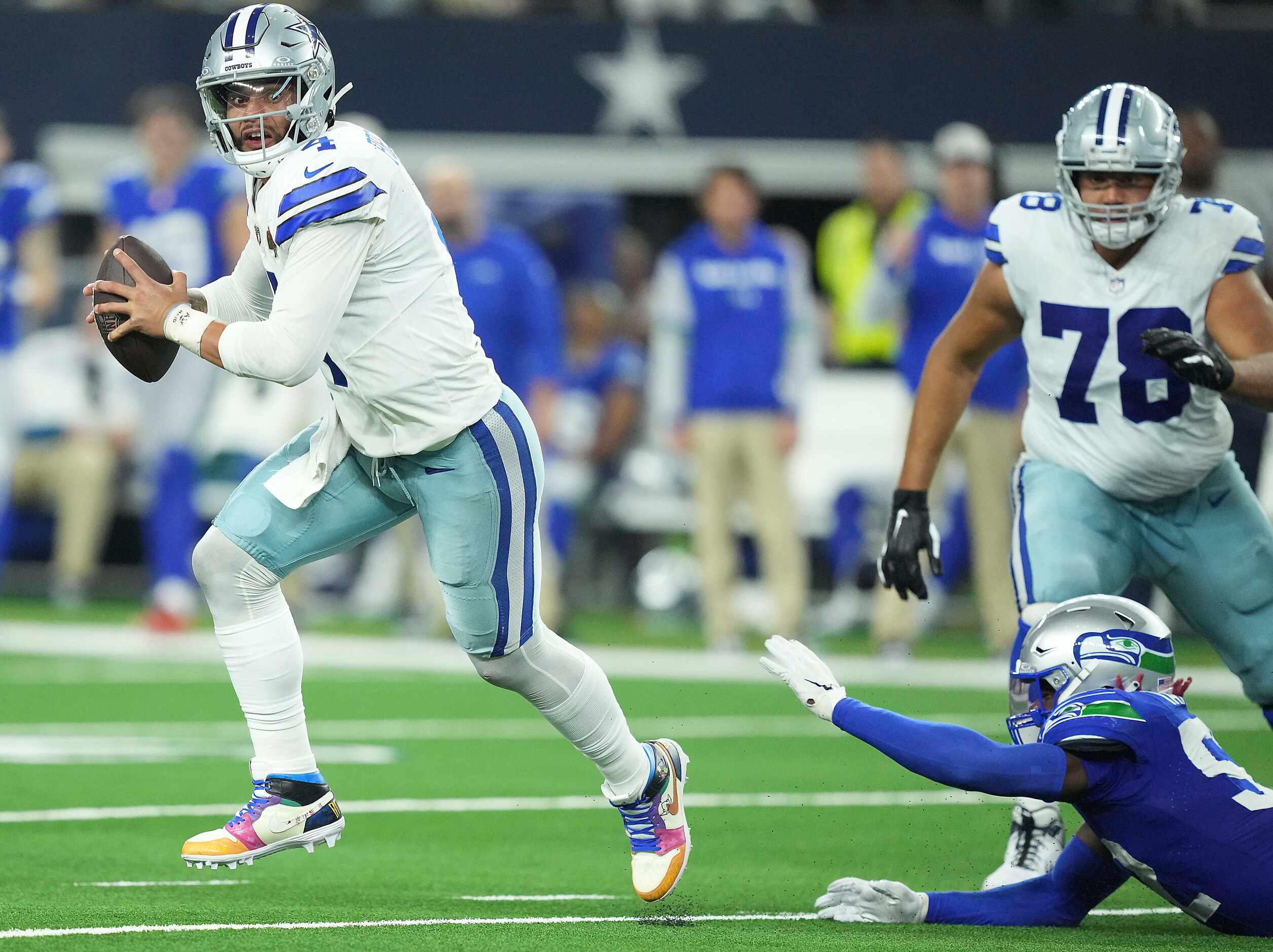 Dallas Cowboys quarterback Dak Prescott (4) scrambles away from Seattle Seahawks linebacker...