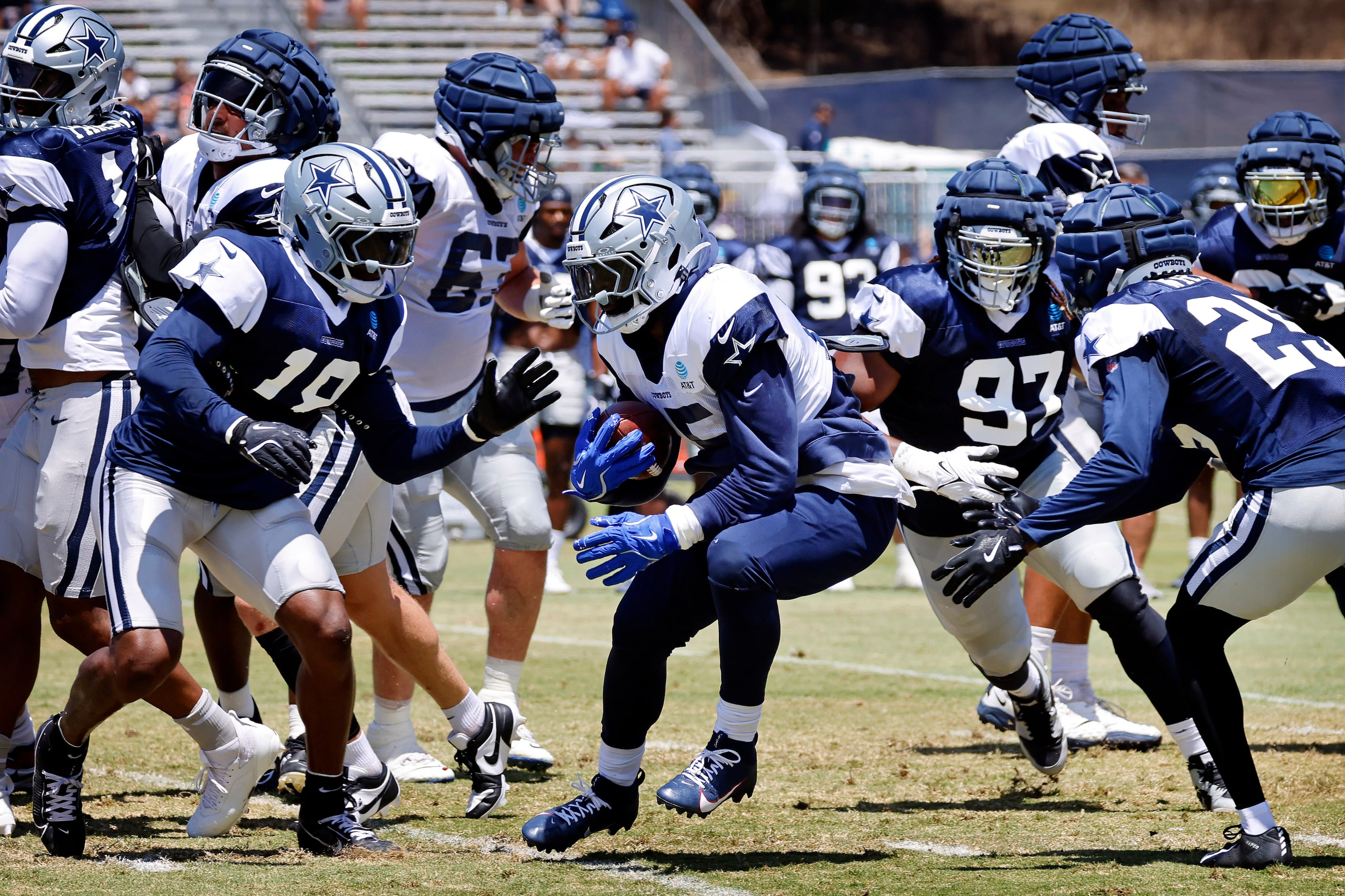 Dallas Cowboys running back Ezekiel Elliott (15) hops through the defense as he finds a hole...